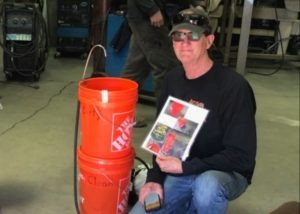 Artisan Metal Works employee displays handwashing station